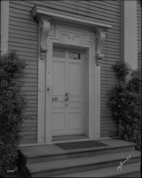 Black and white photograph of ornate front door.