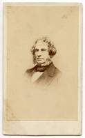 Henry Wadsworth Longfellow with graying sideburns is shown nearly full face. He wears a vest with a diamond pattern with collar, dark neckwear, and coat or suit jacket. Head and shoulders visible.