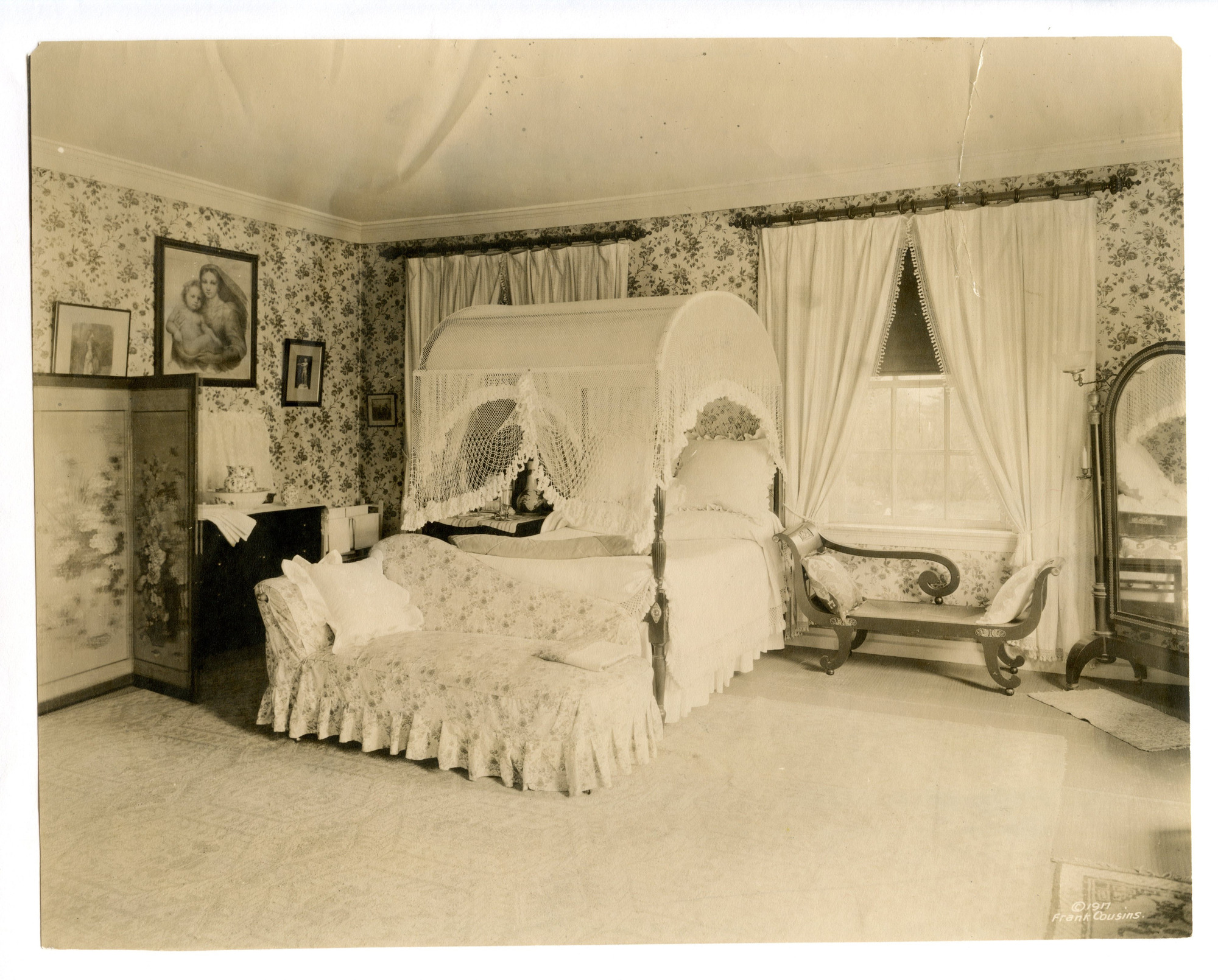 Black and white photograph of 19th century guest room featuring empire style furniture.