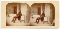 Henry Wadsworth Longfellow sits reading on a veranda. His left arm rests on a table where two books are stacked. A bench and oar are visible in the far left background. Longfellow has ear-length hair and sideburns. He is wearing a dark suit and jacket, possibly with velvet lapels. Two identical copies of the image are printed next to each other on the same card.