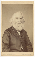 Half-length view. Henry Wadsworth Longfellow is seated and gazes almost directly at viewer. Details of clothing include a slit as his right breast pocket and ribbon hanging from chain beneath coat. Longfellow has chin-length white hair and a full white beard.