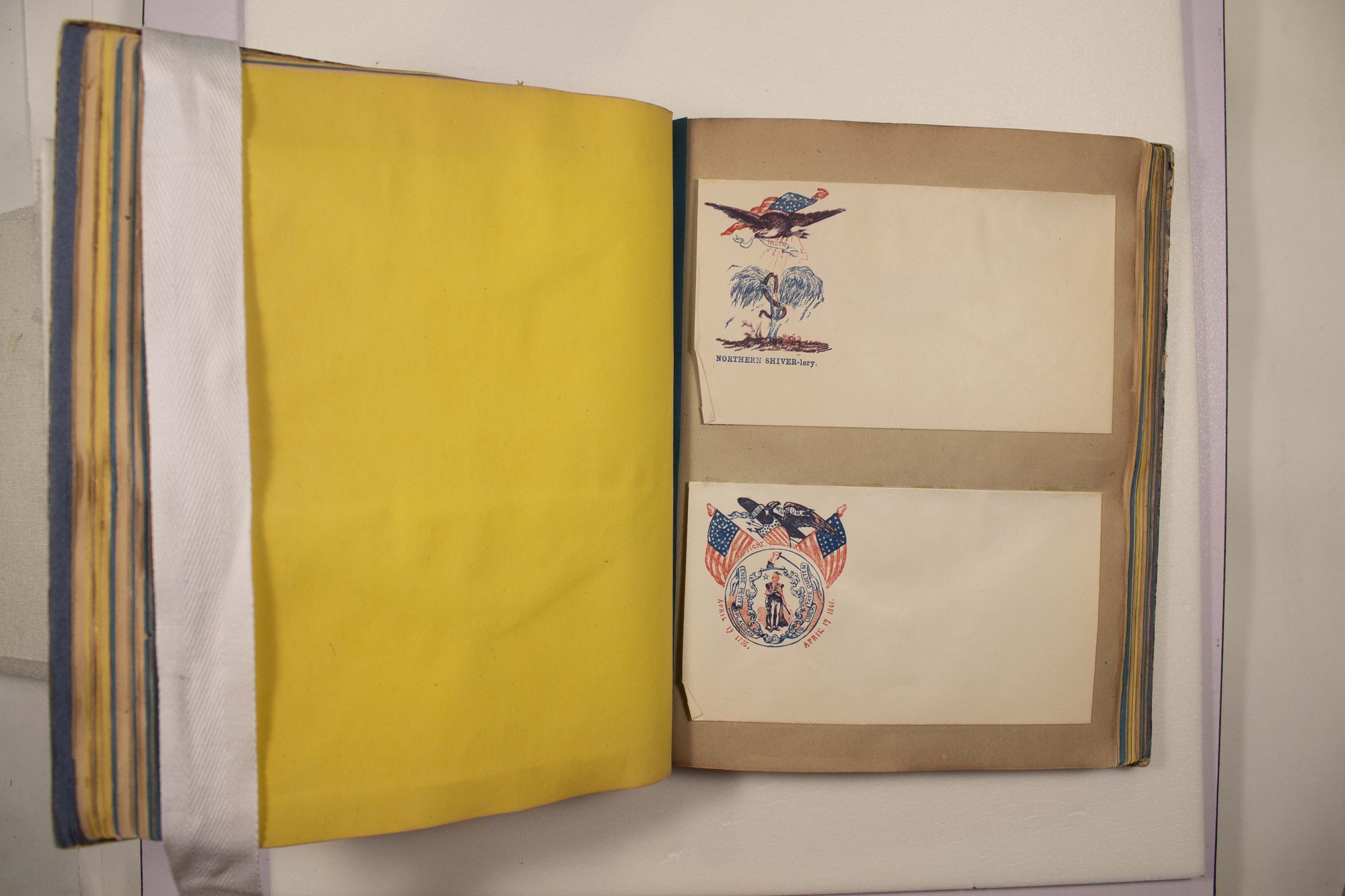 Back of two envelopes which have been glued to page.