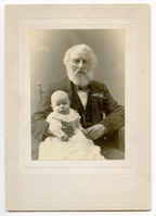 Henry Wadsworth Longfellow is seated, holding very young baby in his lap. Longfellow's left hand touches the baby's left hand. Longfellow wears a suit and has ear-length white hair and a full white beard. The baby wears a white gown.