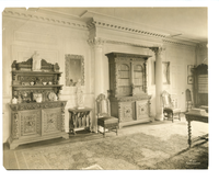 Black and white photograph of large 19th century library, with Renaissance revival bookcases.