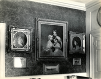 Three ornately framed portraits of young women and three smaller landscape paintings.