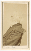 Half-length portrait. Henry Wadsworth Longfellow is seated, full profile to viewer's left. The curving chair rail is partially visible. Longfellow's chin-length hair and long beard are white.