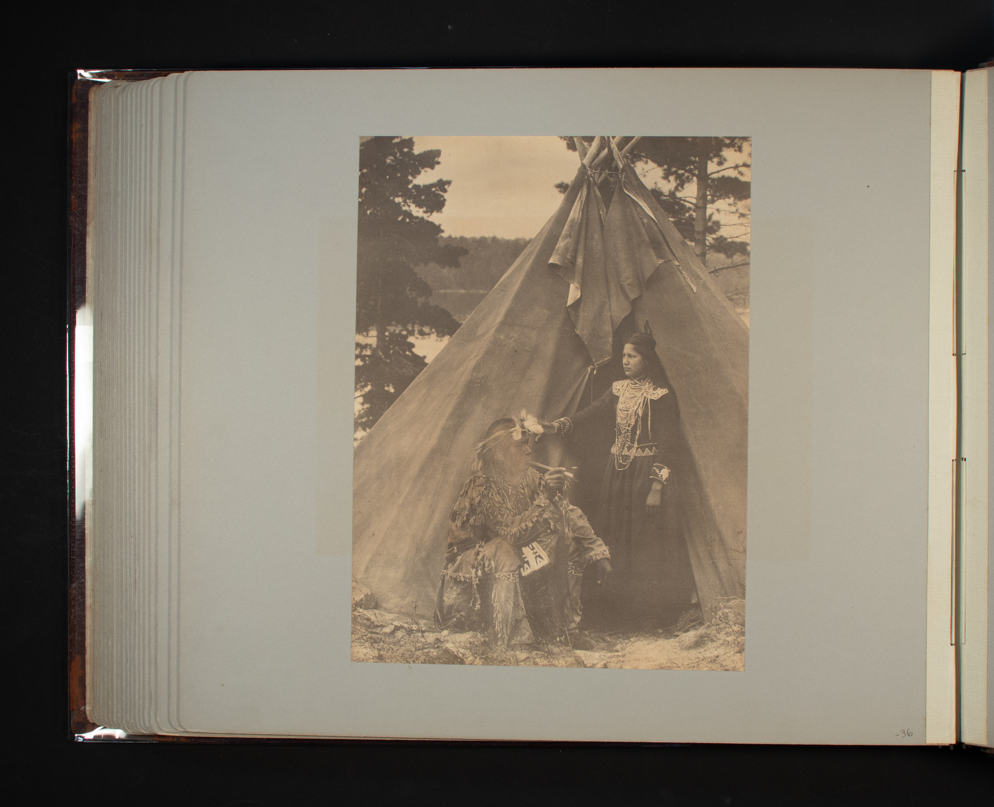 Woman and man by the entrance of a tipi