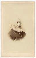 Portrait of Henry Wadsworth Longfellow. Head and shoulders visible against blank background. He is at three-quarter view to his left. Longfellow's chin-length hair is white and his mid-length beard is white and gray.