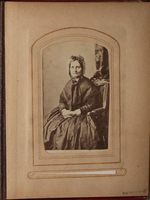 Black and white photograph of older woman sitting in chair.