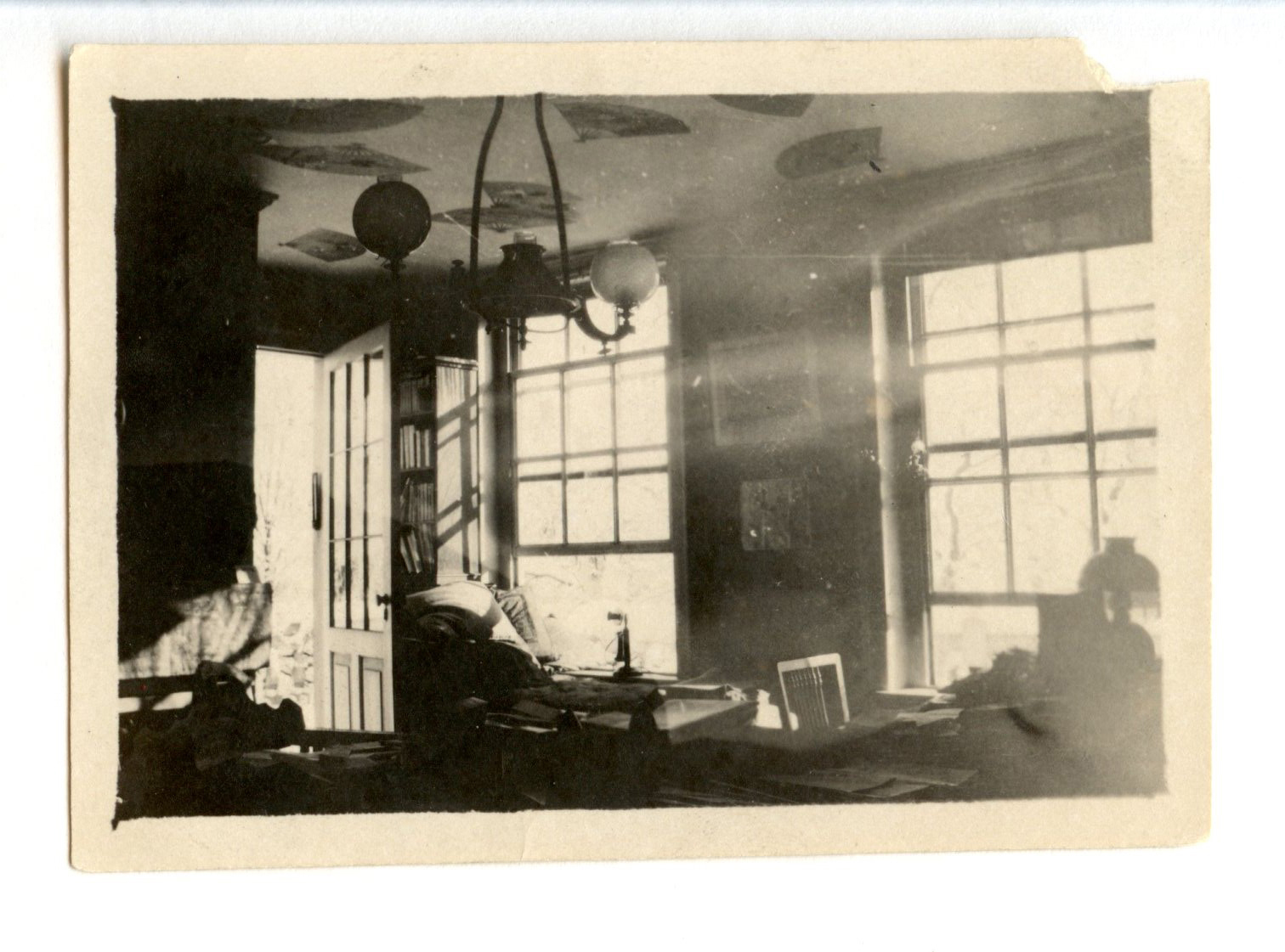 Black and white photograph of small 19th century sitting room.