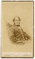 Half-length portrait. Henry Wadsworth Longfellow is sitting in a chair with his body in three-quarter position turned to his right. The heavily carved back and upholstery of a Rococo Revival chair are visible. Longfellow has ear-length hair and sideburns and is wearing formal attire.