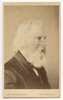 Almost full-profile view of Henry Wadsworth Longfellow head and shoulders. He is facing viewer's right. Longfellow wears formal attire and has chin-length white hair and a full white beard.