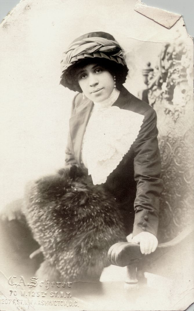 Post card of Mattie Frazier dressed in hat and hand fur