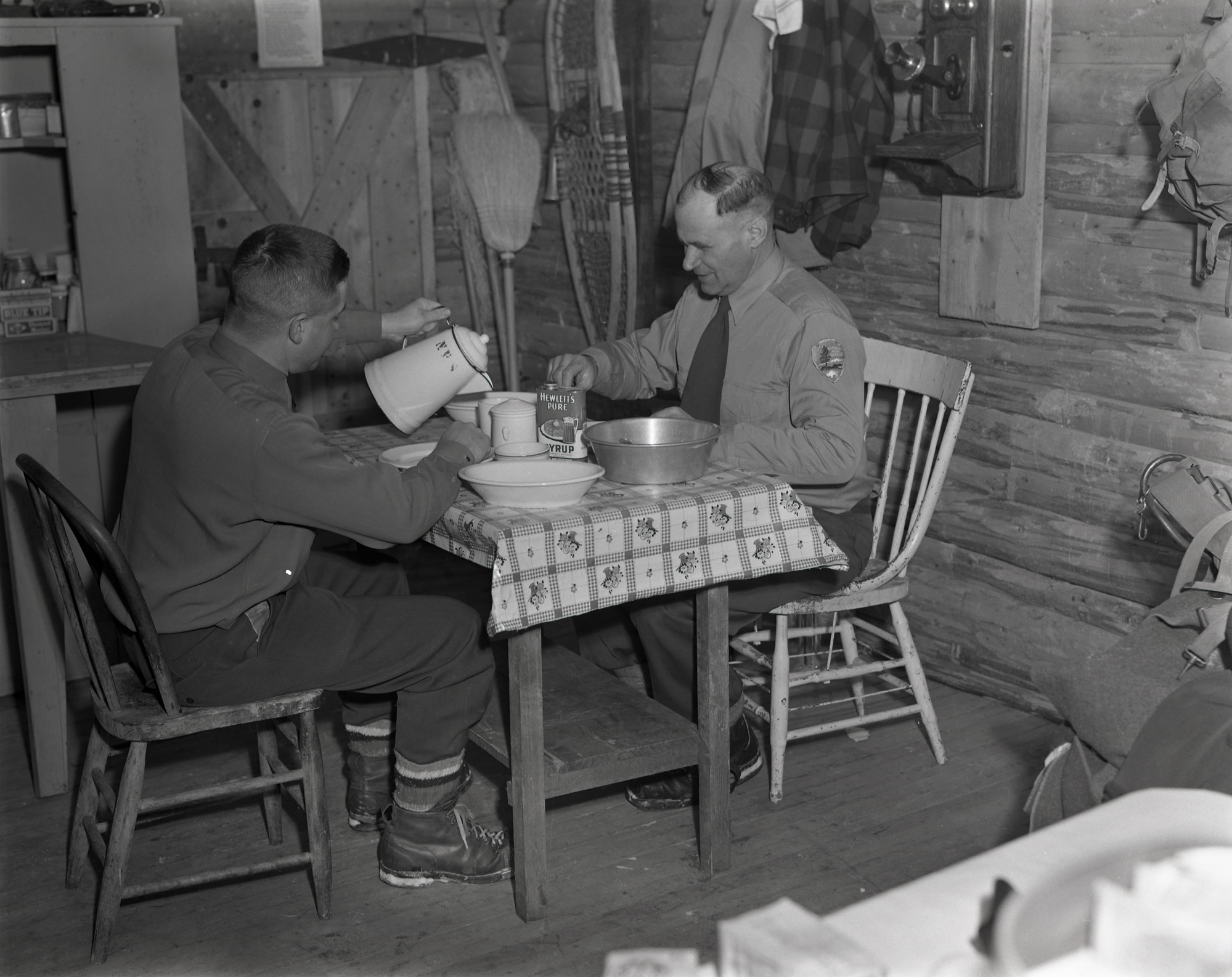 (Park Rangers Breakfasting in Backcountry Cabin)