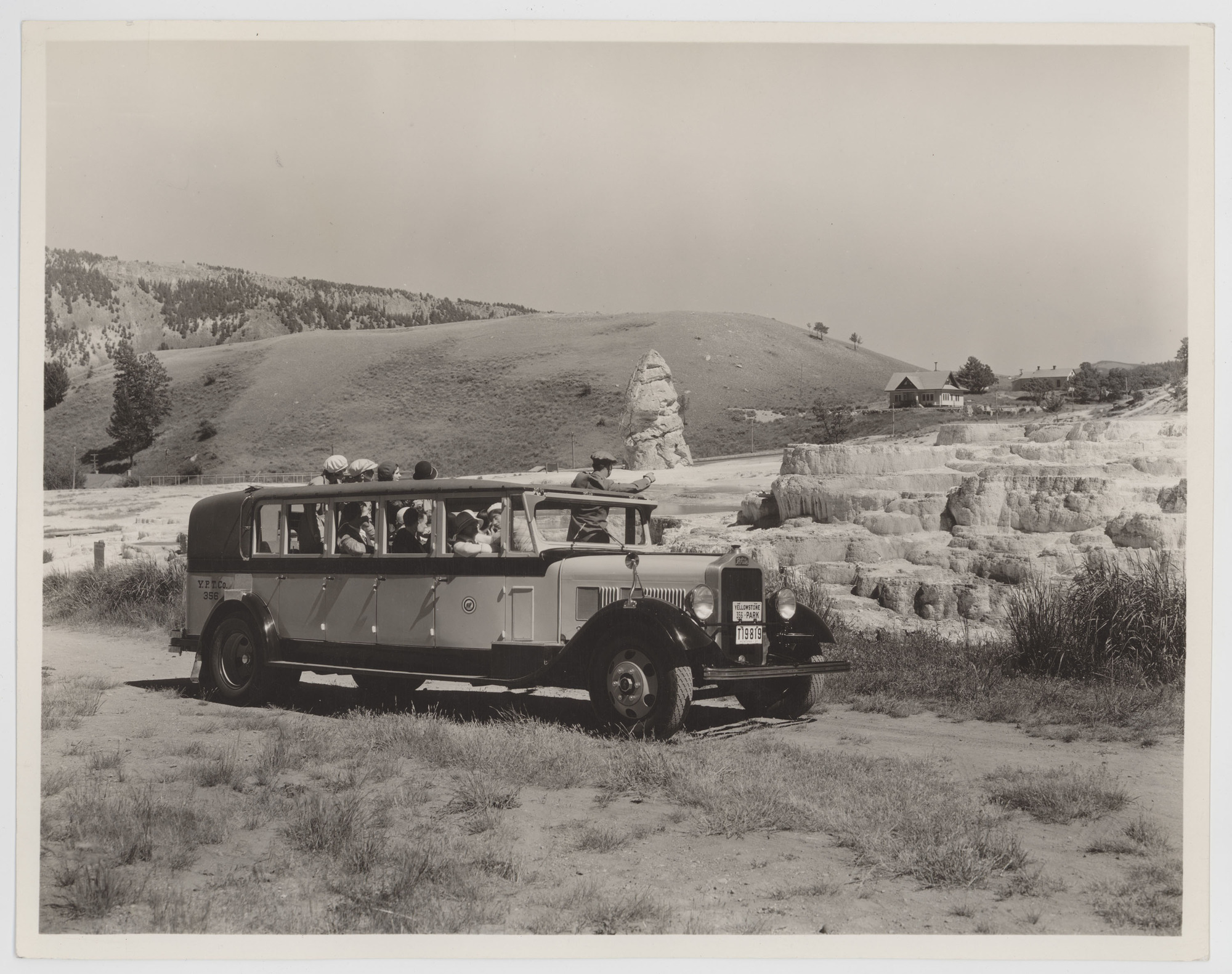 Visitors in Yellowstone White Bus by Mammoth Terraces