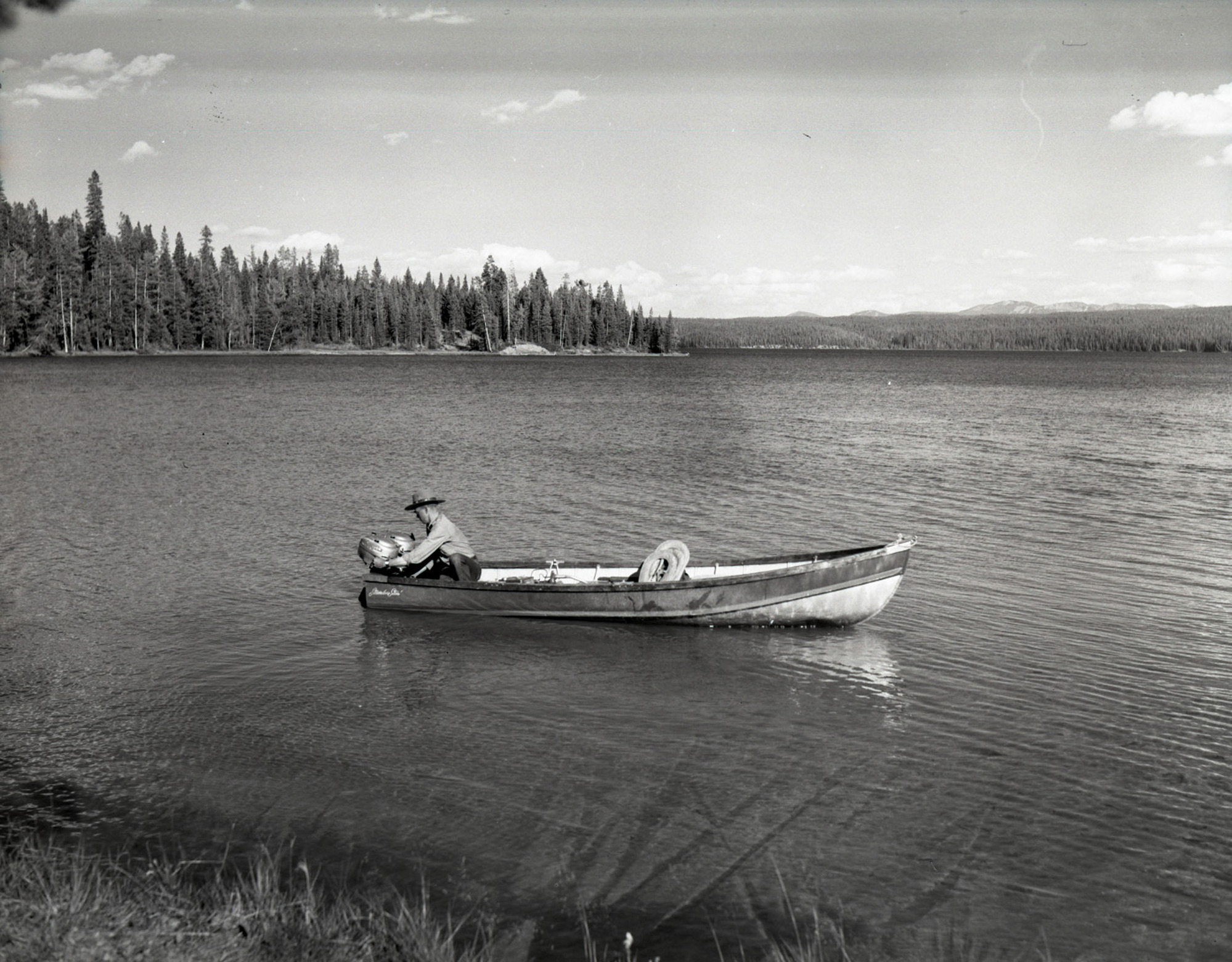 Ranger Nat Lacy in patrol boat on Shoshone Lake