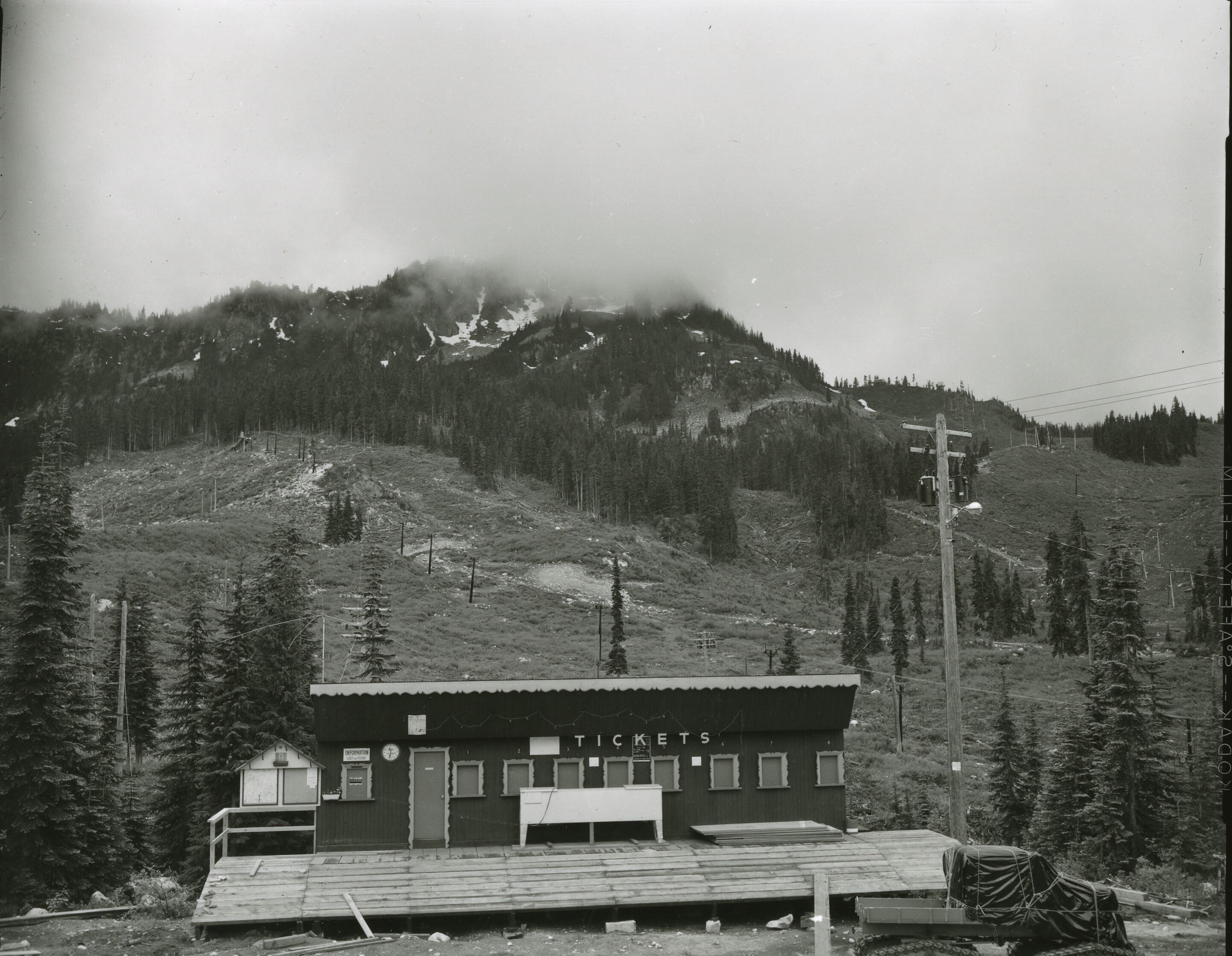 A building with several windows and a sign that reads TICKETS.