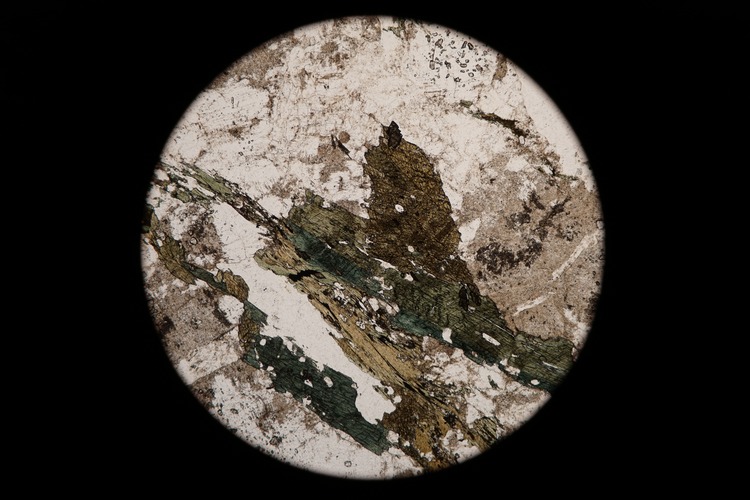 Circular microscopic image of rock structure.