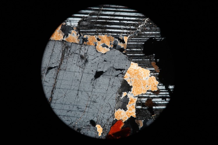 Circular microscopic image of rock structure.