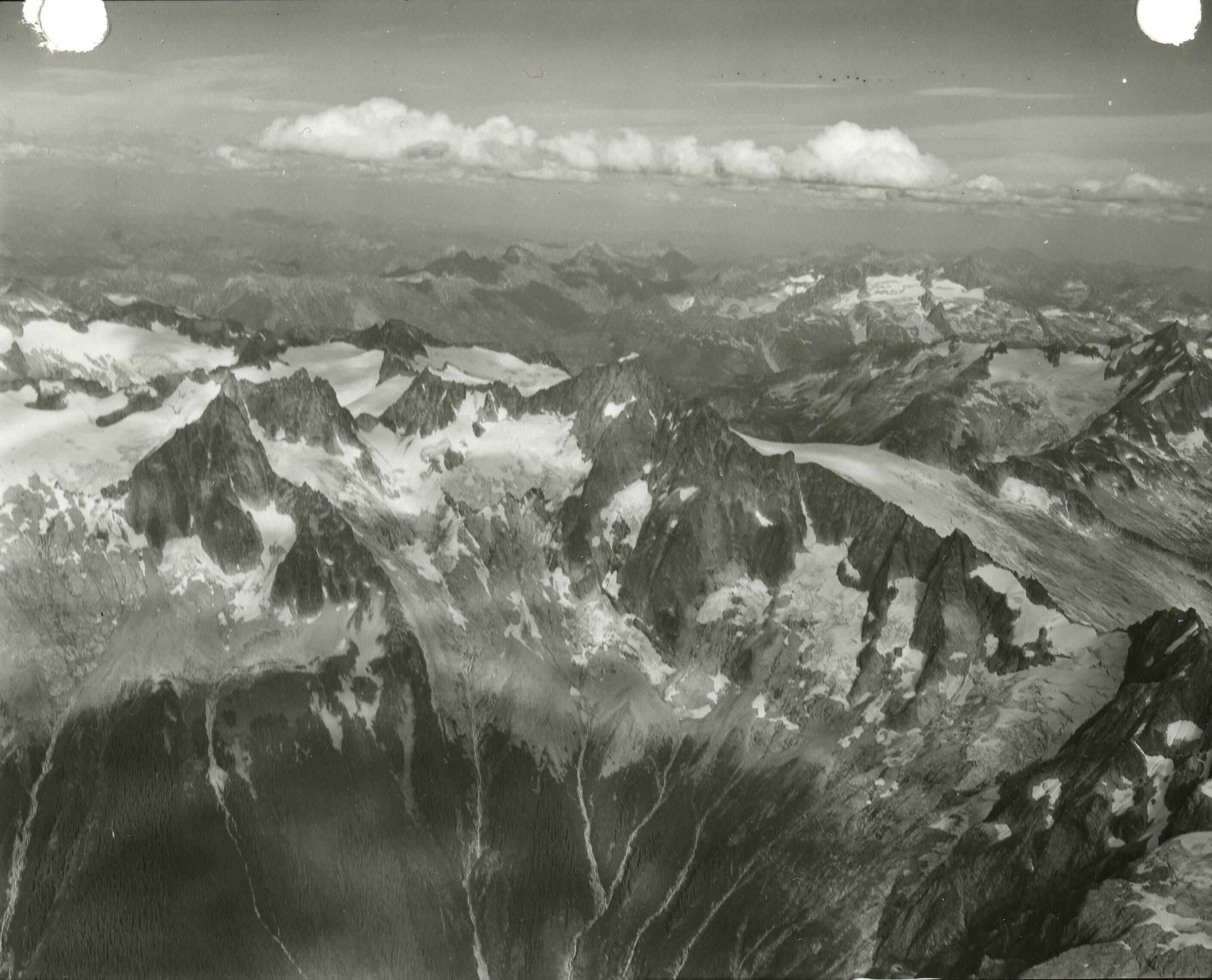 Aerial view of rocky mountains with some snow and ice.