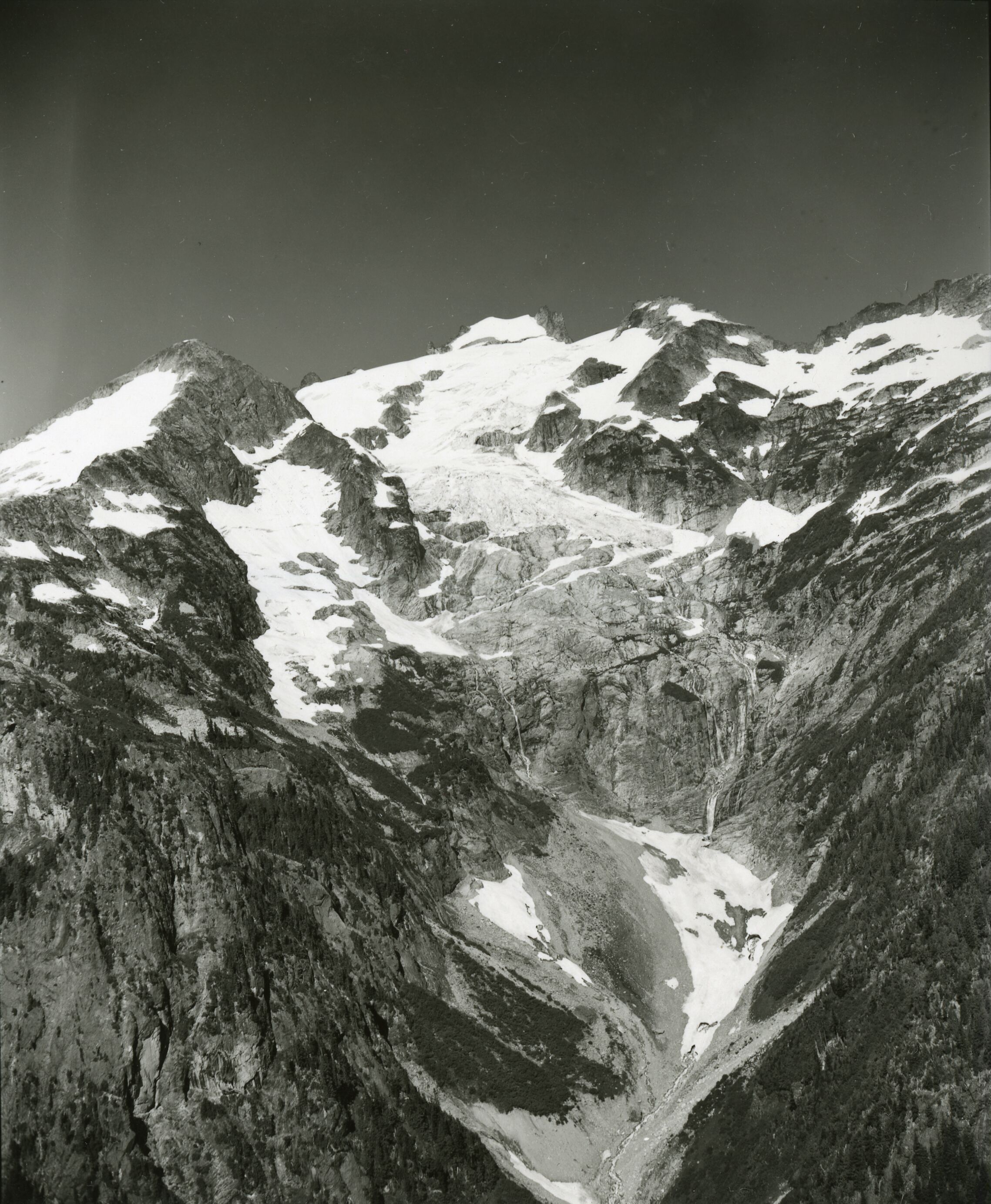 A glacier cascading down the side of a mountain.