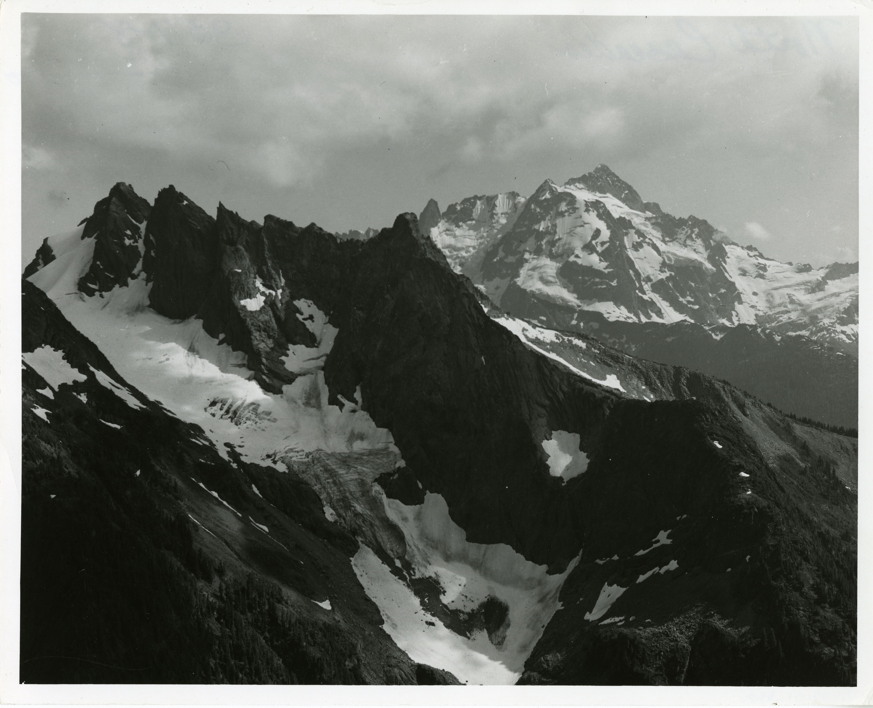 Sharp mountain ridges with a small glacier in foreground.