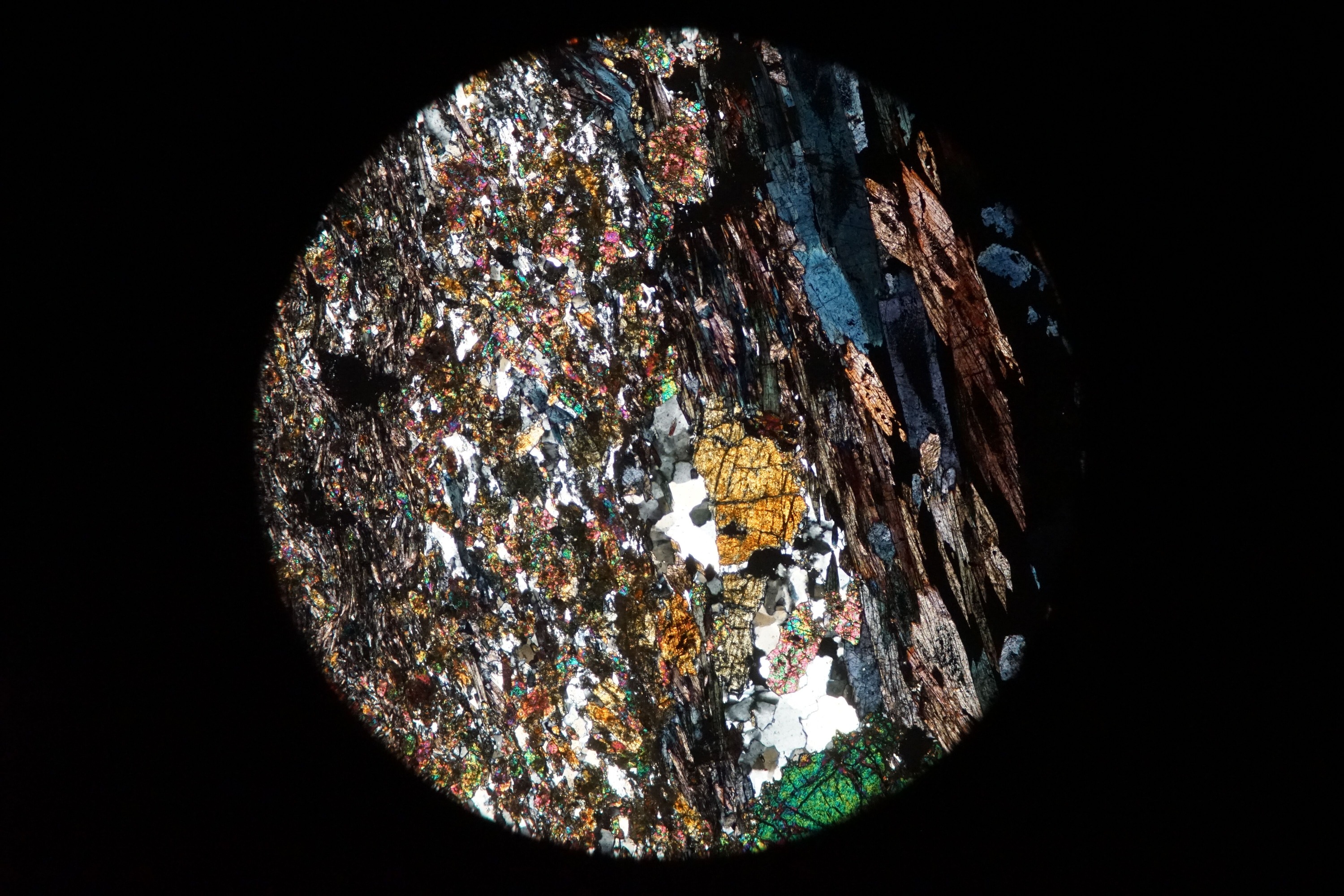 Circular microscopic image of rock structure.