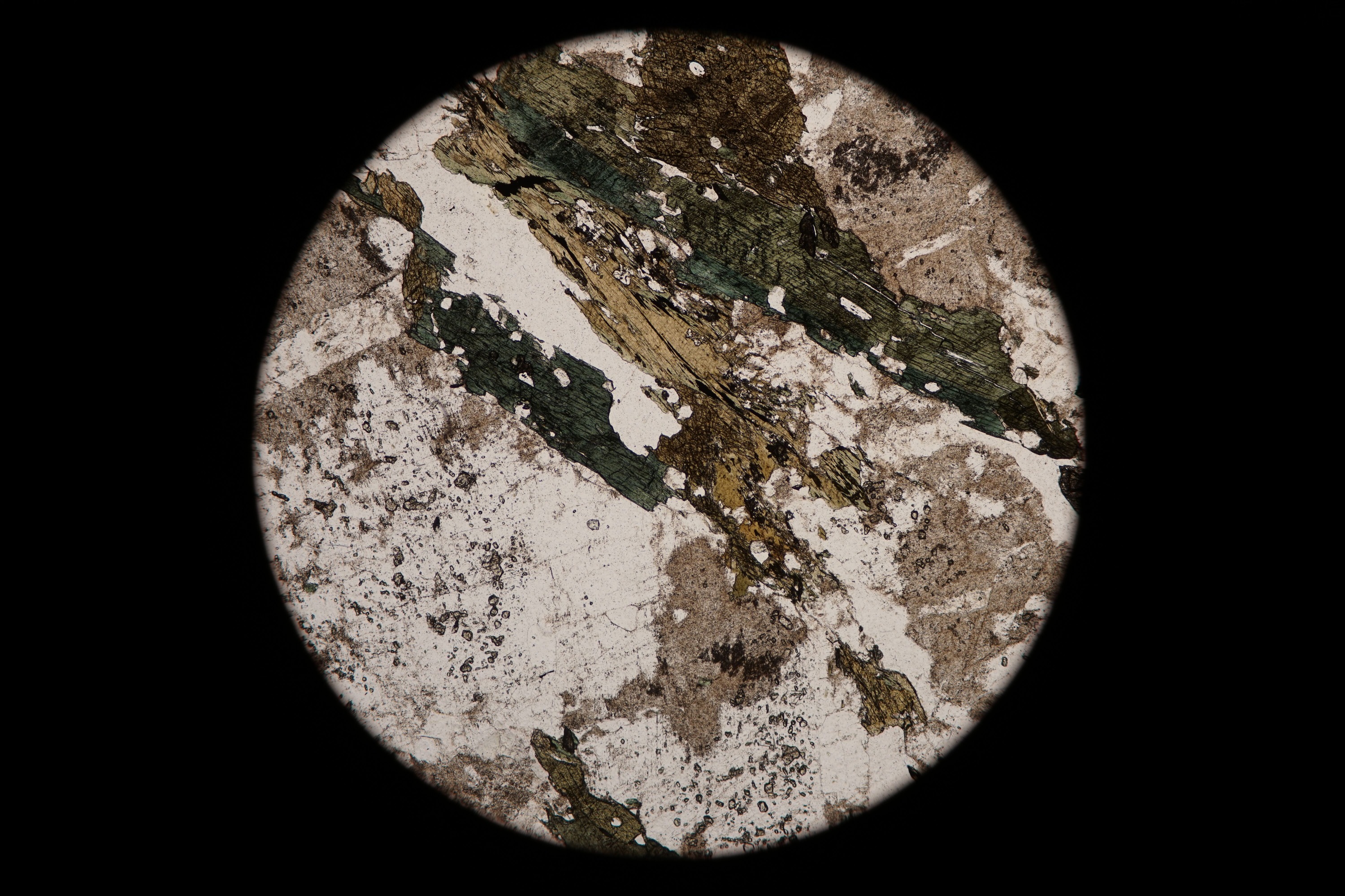 Circular microscopic image of rock structure.