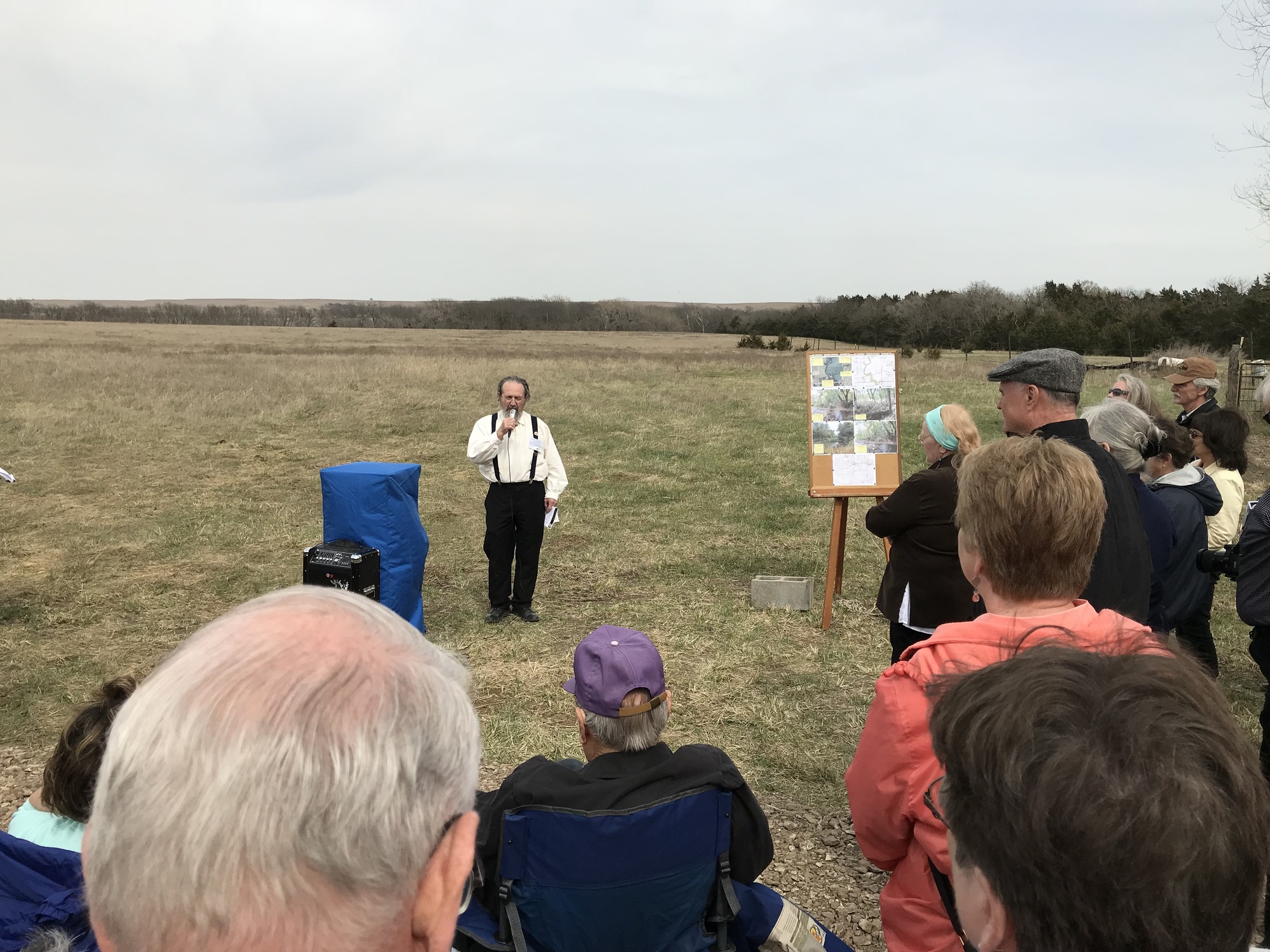 A group of people standing in a field.
