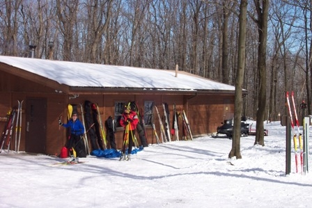 a couple cross-country skiers prepare to hit the trails in Laurel Ridge State Park