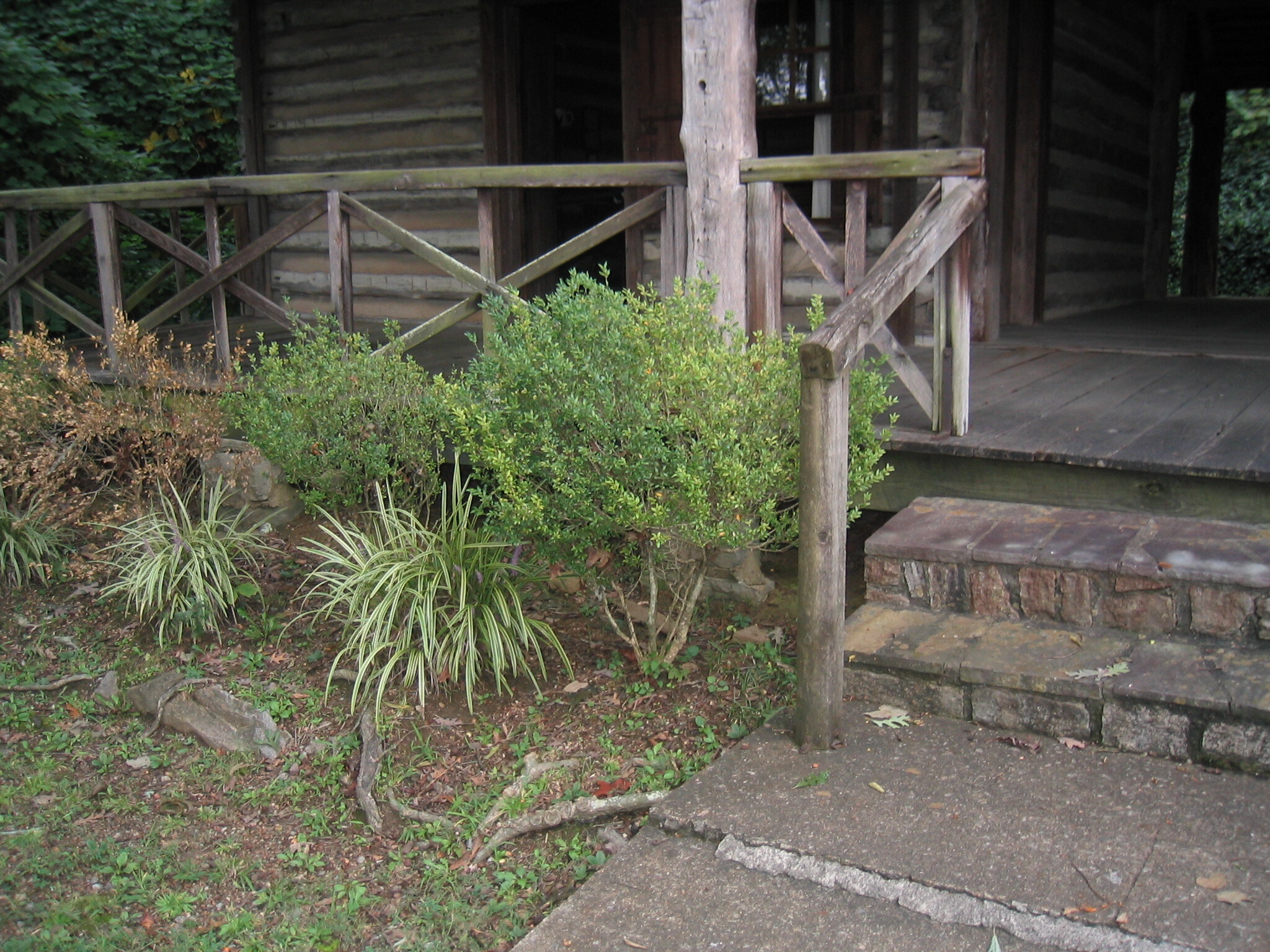 A wooden porch with a wooden railing.