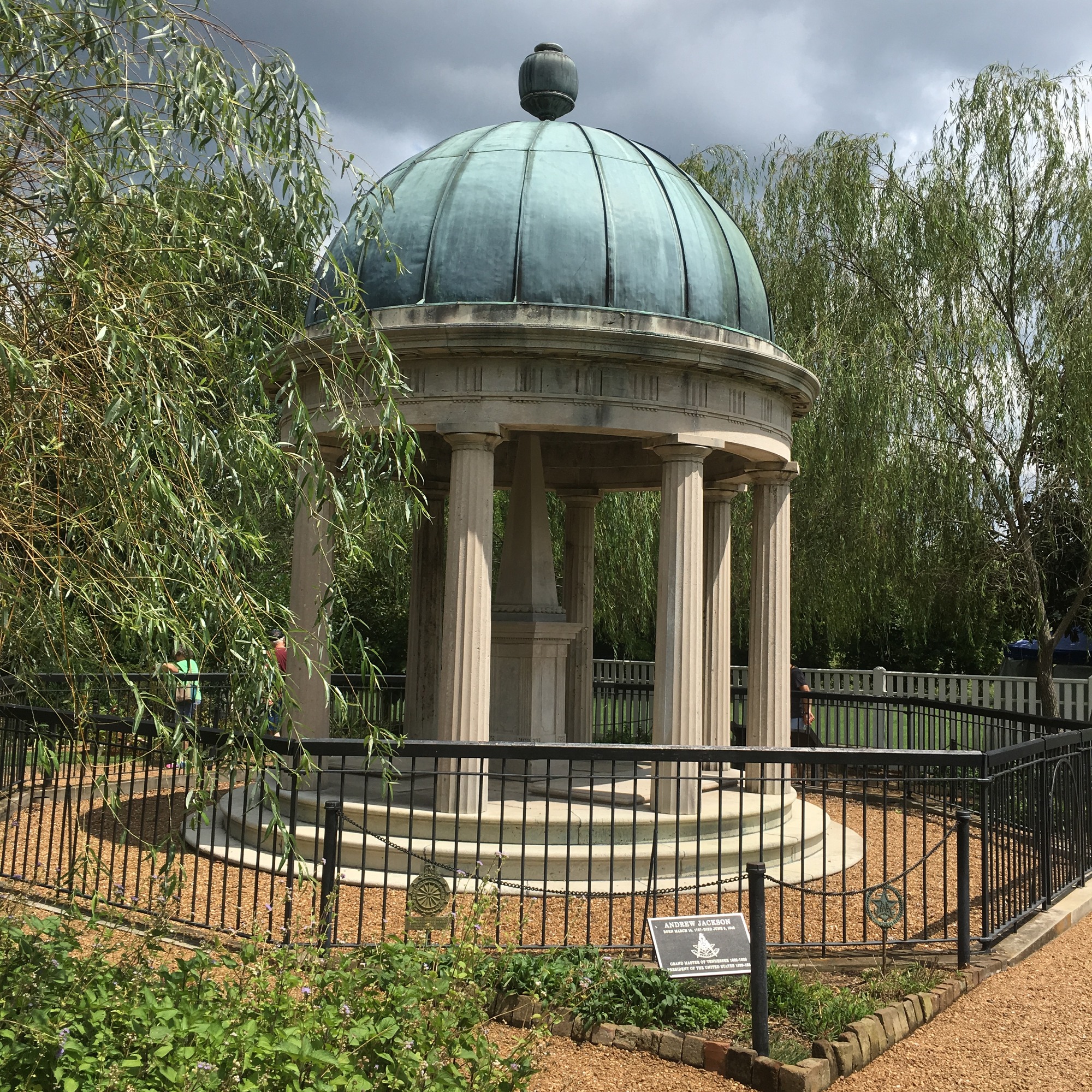 A gazebo in surrounded by trees.
