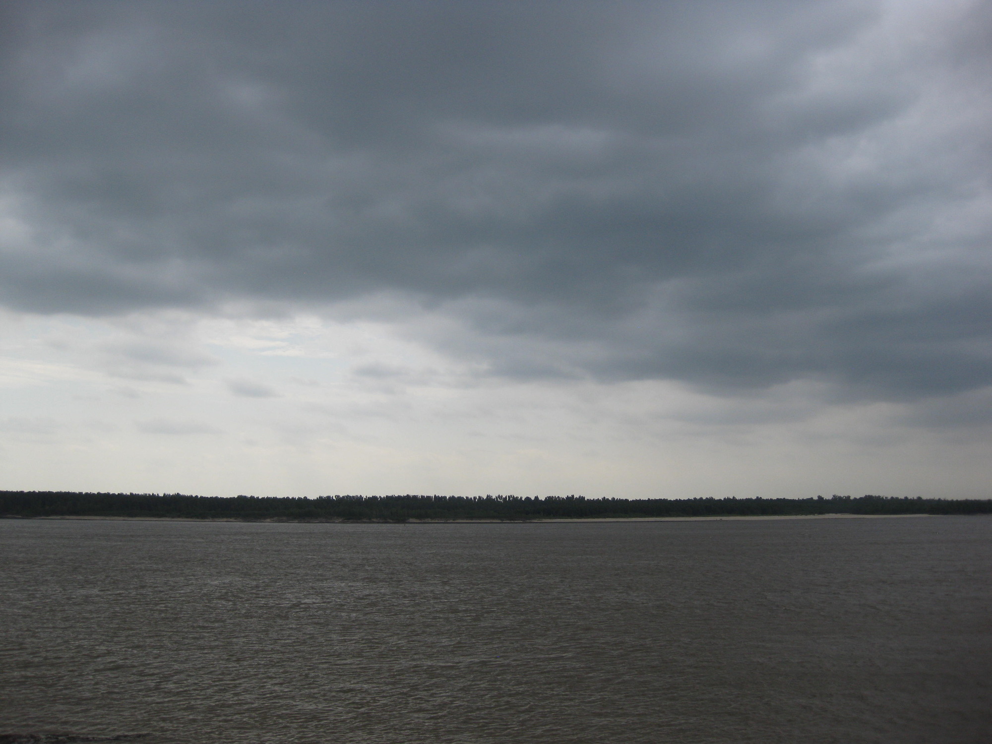 A cloudy sky over a body of water.