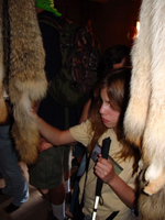 A girl holding an item inside a room.