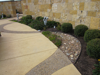 A stone wall beside a gravel path.