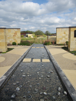 A water fountain in the middle of a walkway.