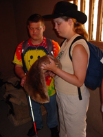 A group of people exploring some item inside a room.