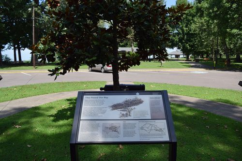 A wayside in front of a tree.