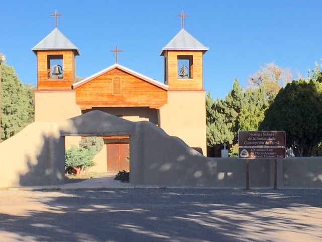 An entrance to a building with trees in the background.