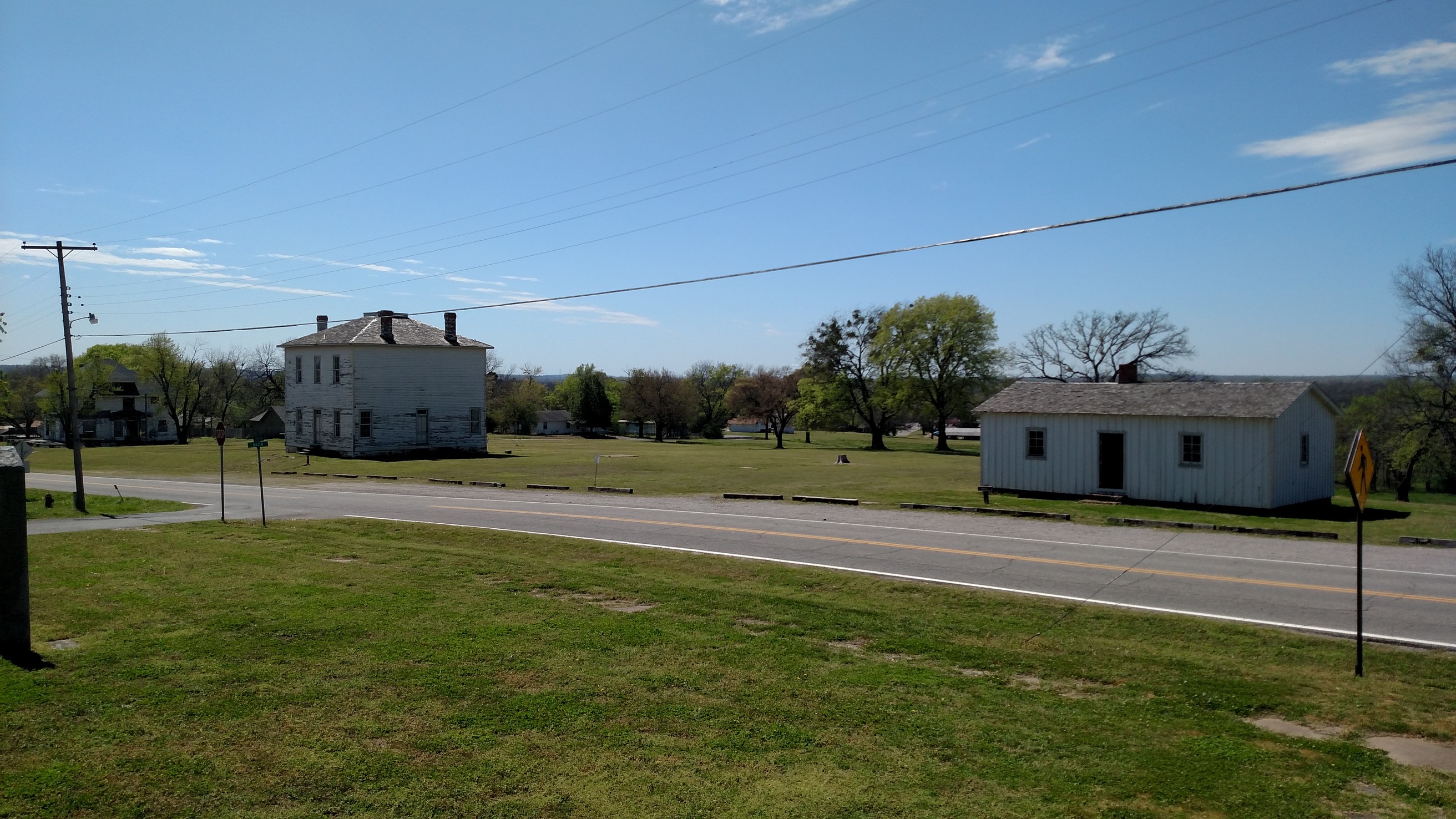 A view of a small town with a few houses and a road.