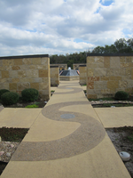 A walkway in the middle of a stone wall.