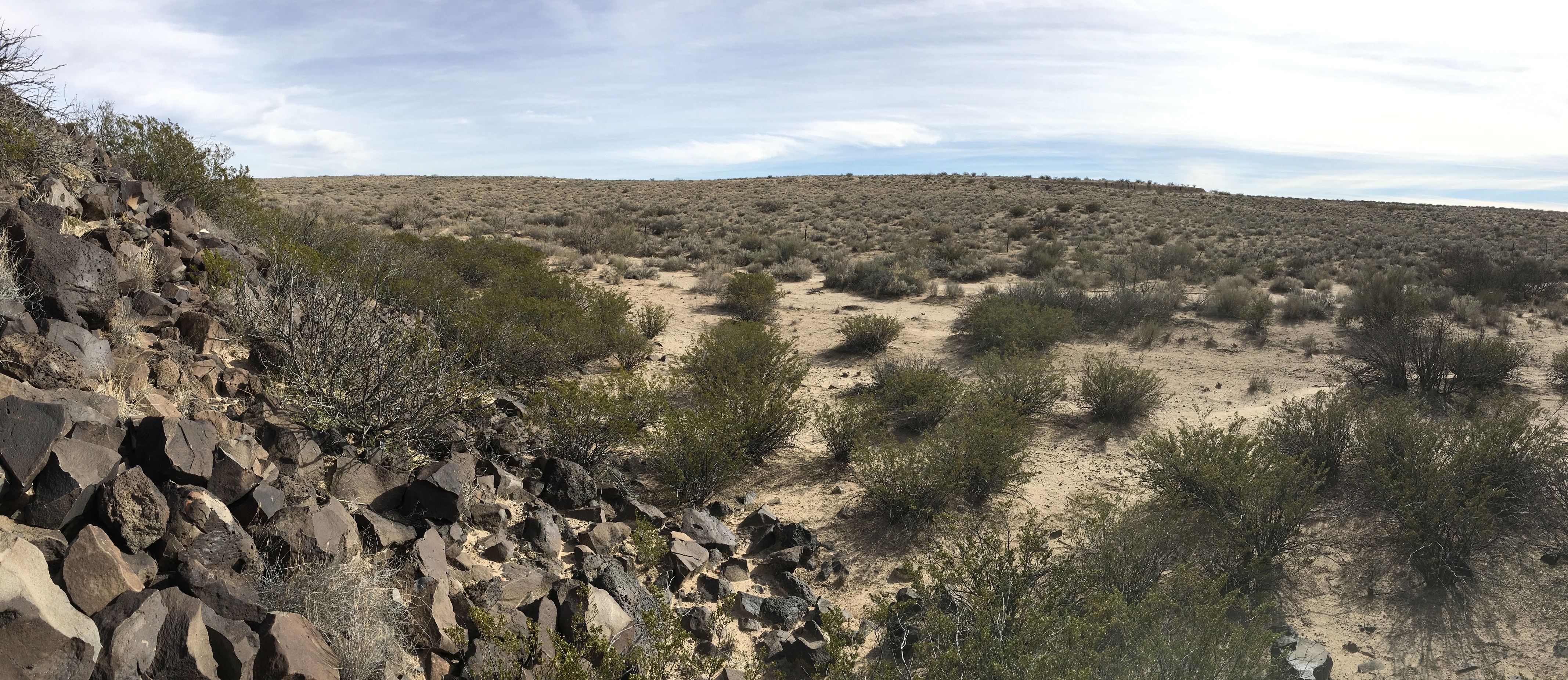 A pile of rocks in a middle of a desert.