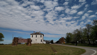 Some buildings sit on the side of a road.