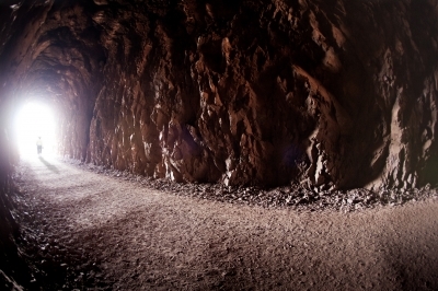 Visitor exits in a glow of light at the Historic Railroad Trail, Lake Mead NRA.