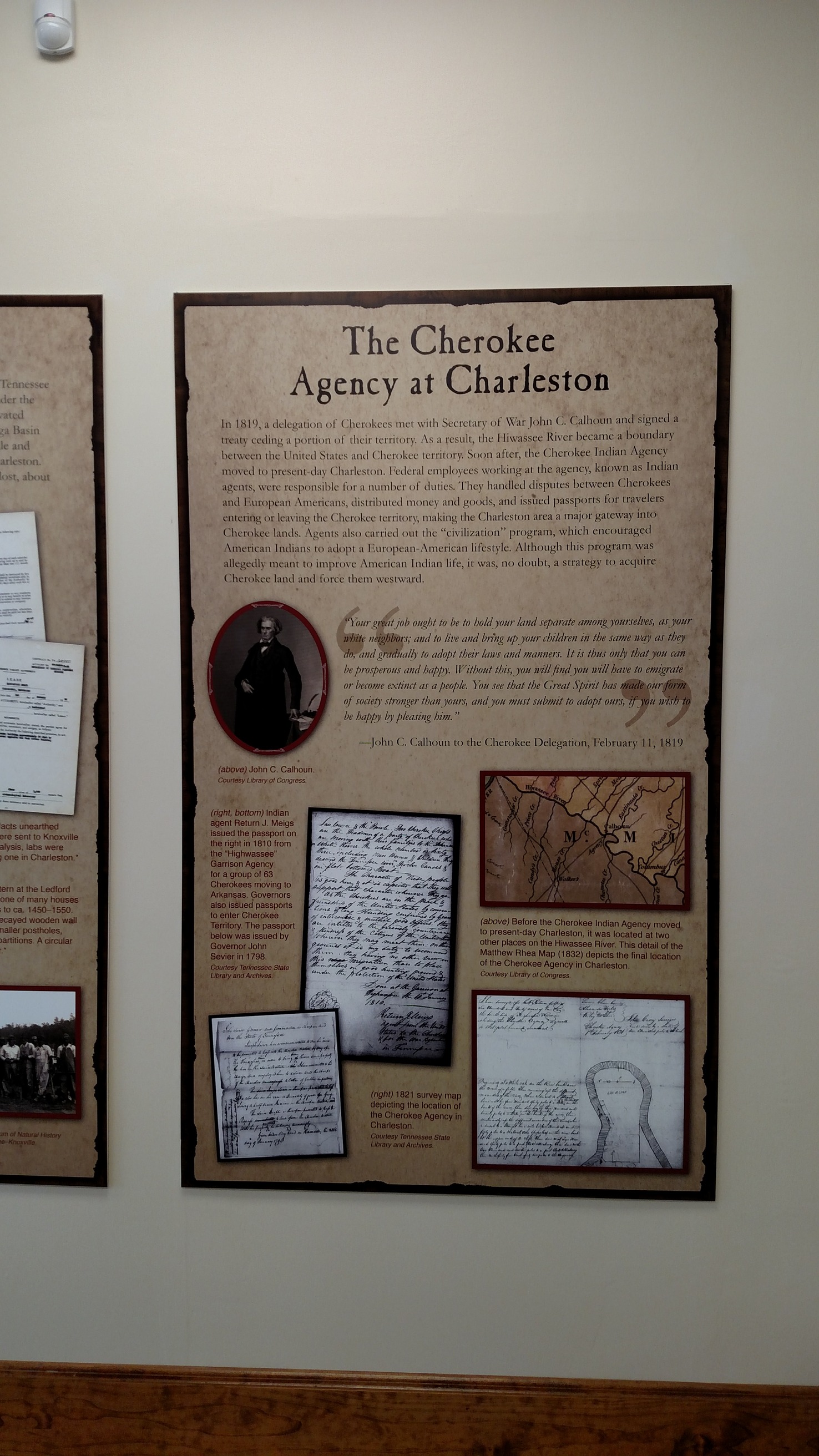 A vertical poster with text and images in a wall.