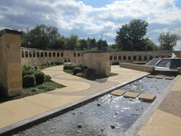 A stone walkway with a water feature.