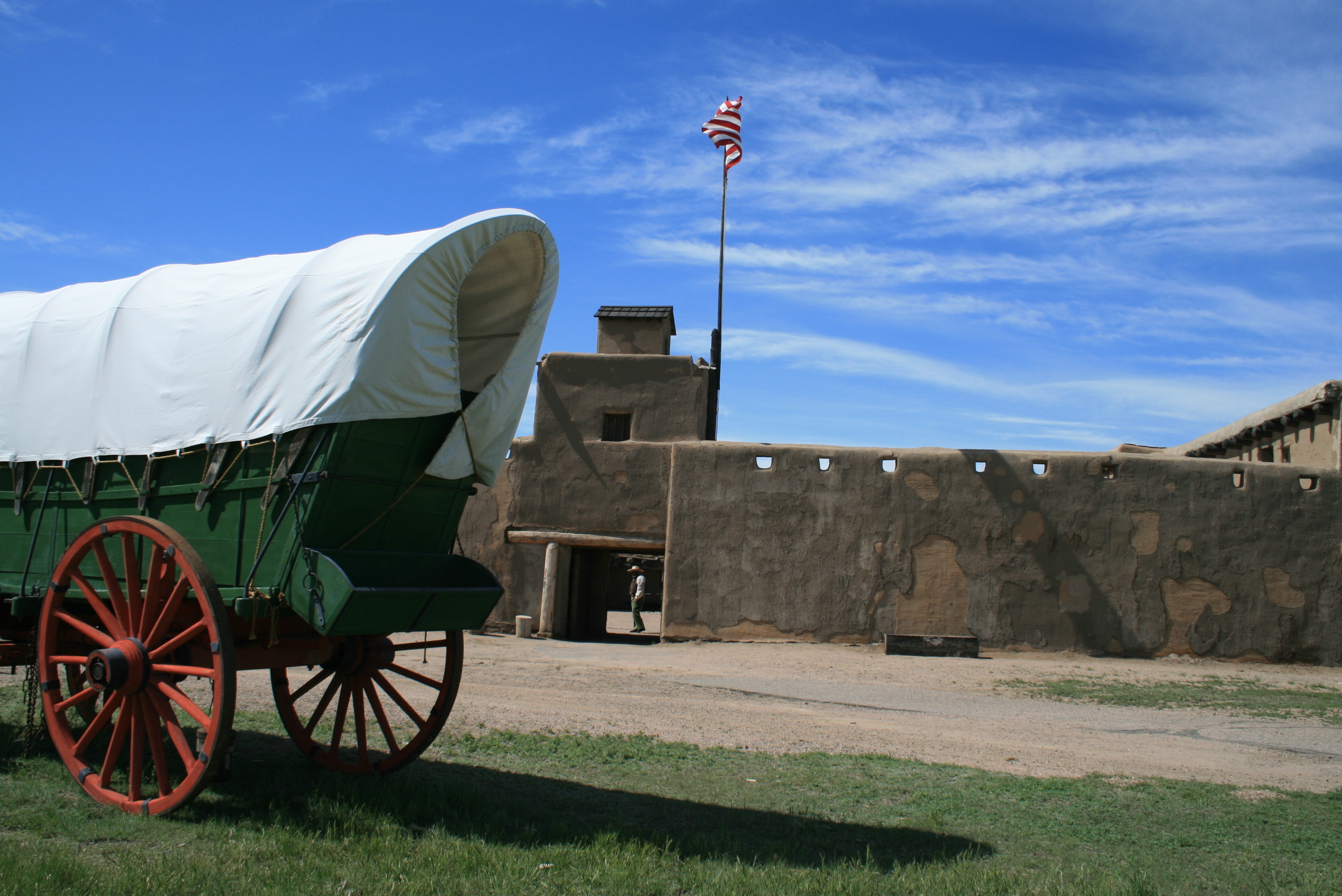 Flag waving by a wagon at Bent's Old Fort National Historic Site