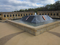 A fountain in the middle of a stone wall.