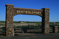 An archway with a sign titled 