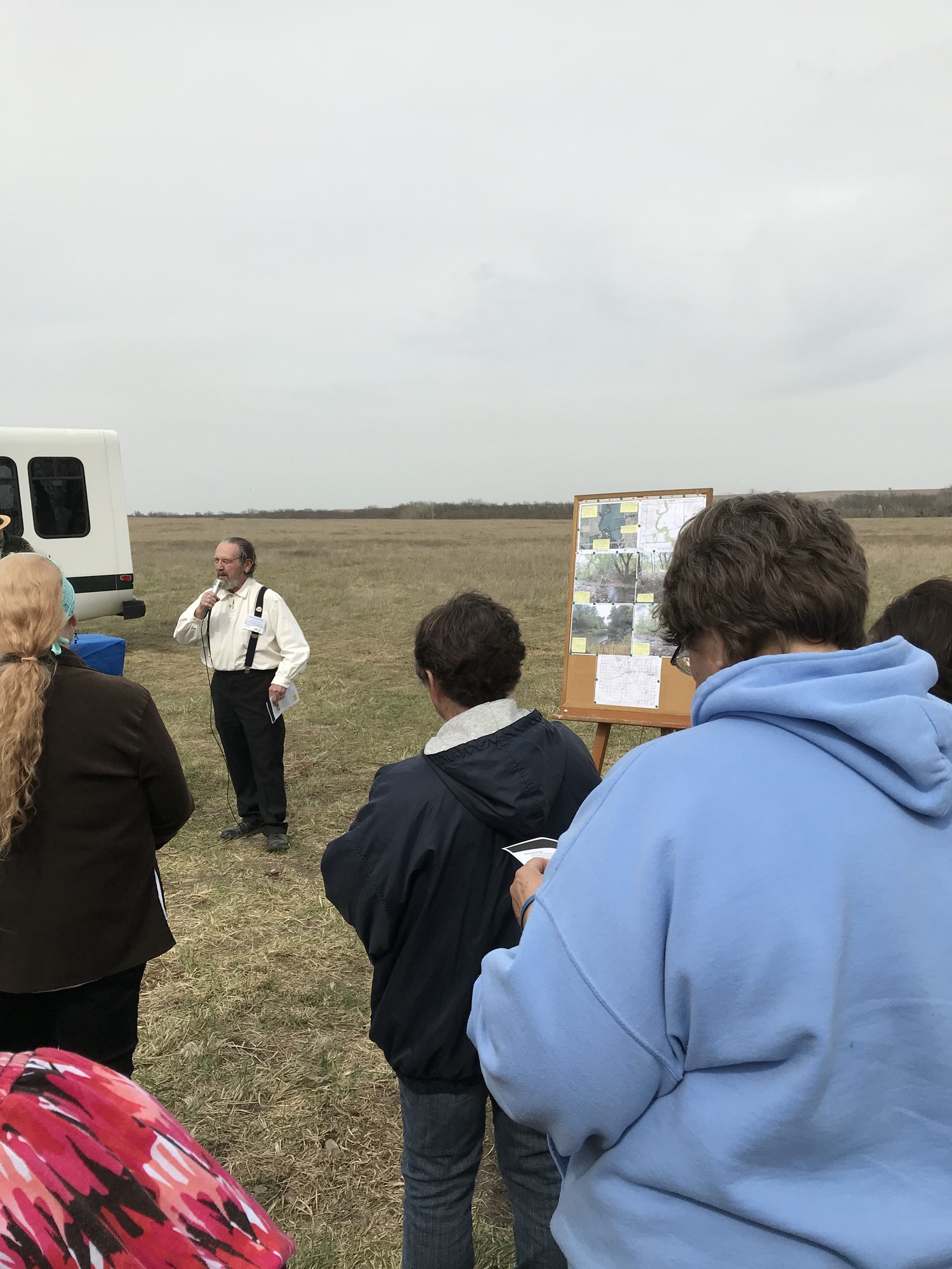 A group of people standing in a field.